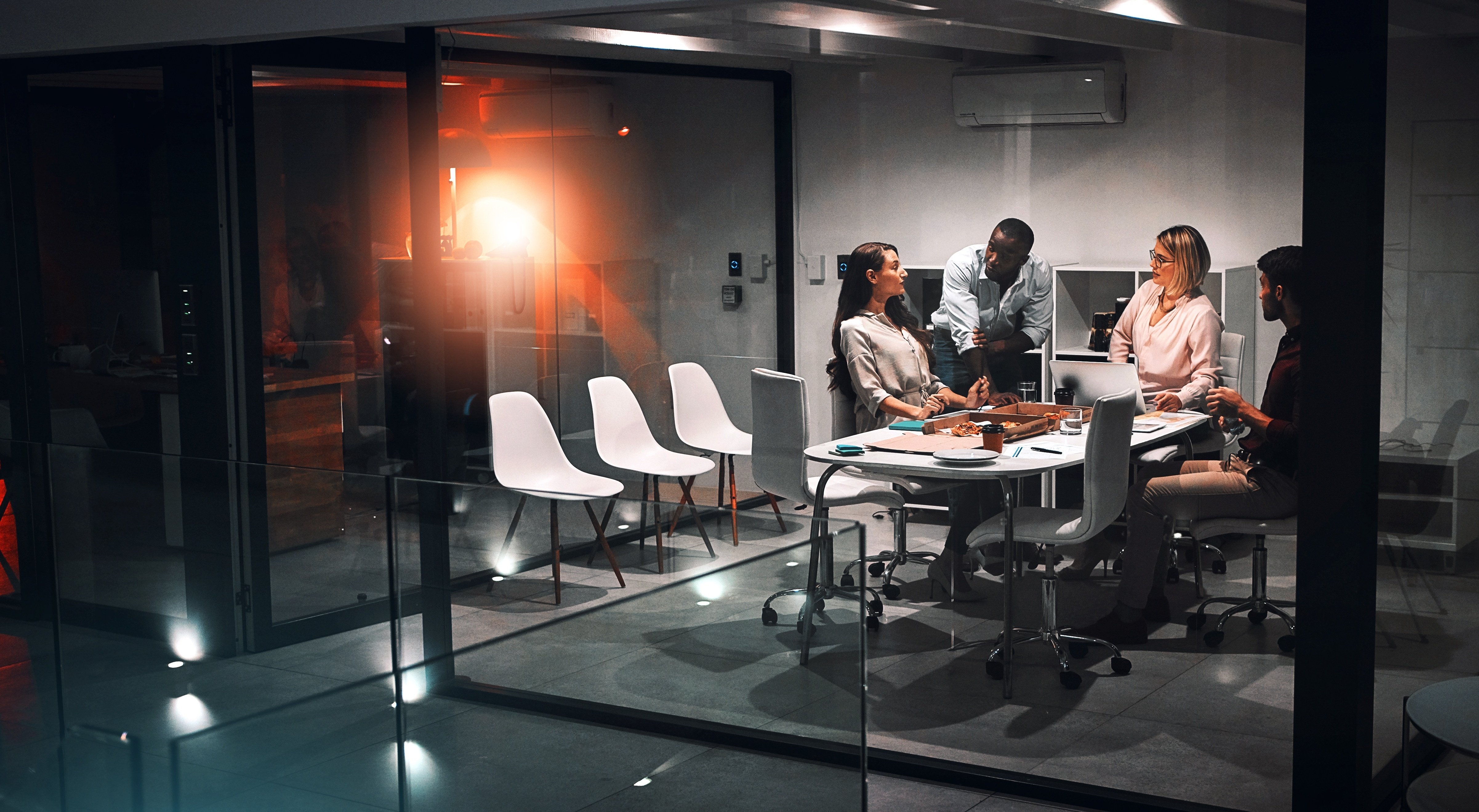 A team discusses challenges in a meeting room.